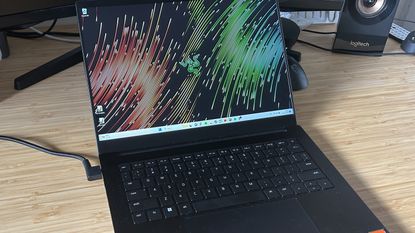 Razer Blade 14 gaming laptop open on a wooden desk