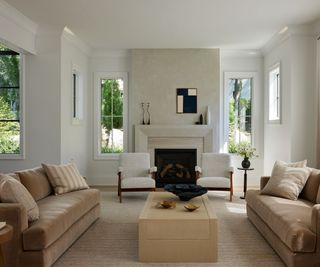 living room taupe sofas white walls and fireplace