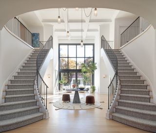 A foyer with floor-to-ceiling windows