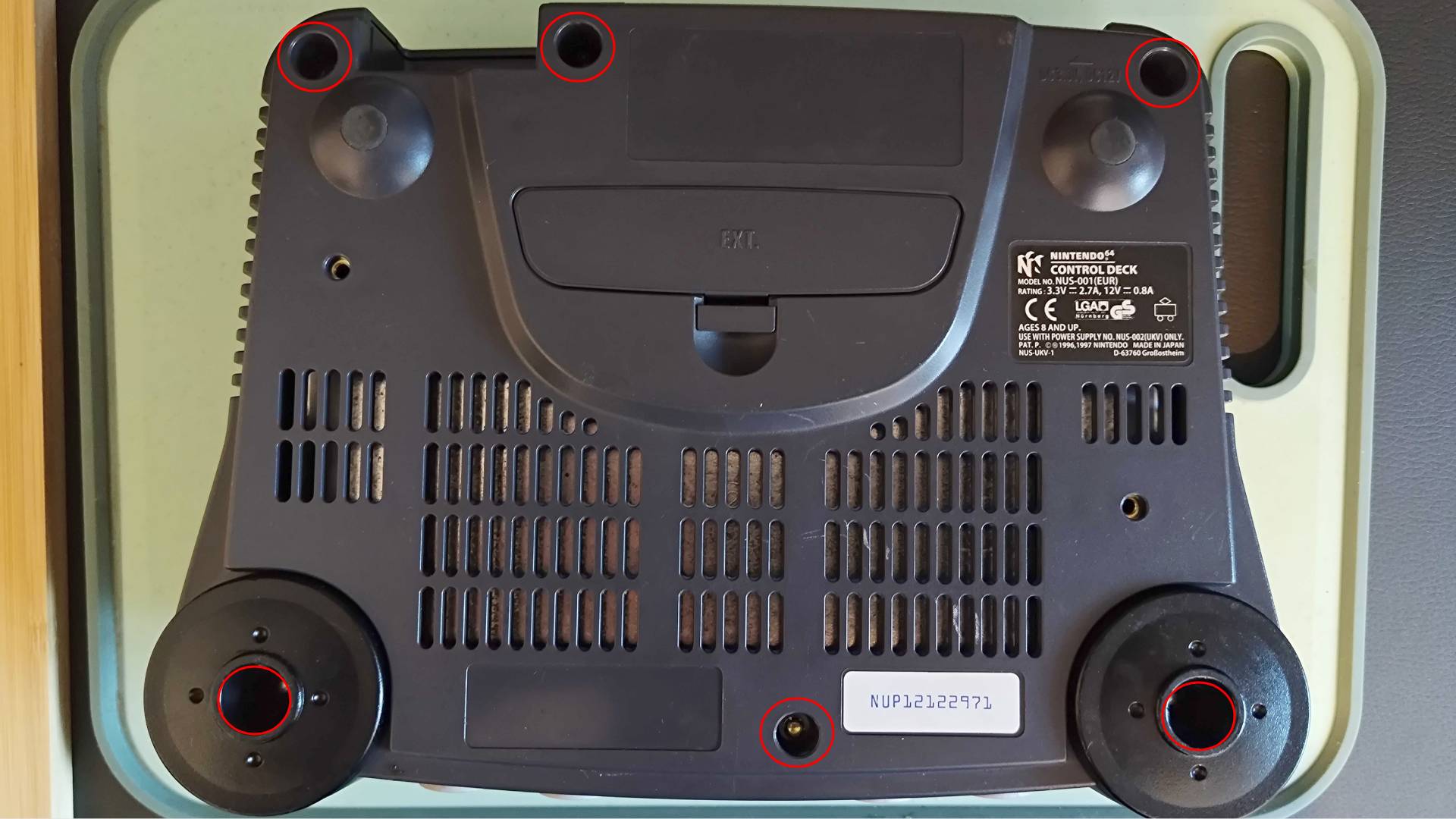 N64 with red circles highlighting bottom screw hole placement.