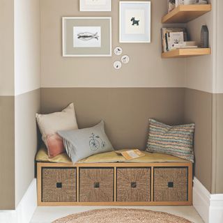 A living room alcove with a storage bench seat and floating shelves