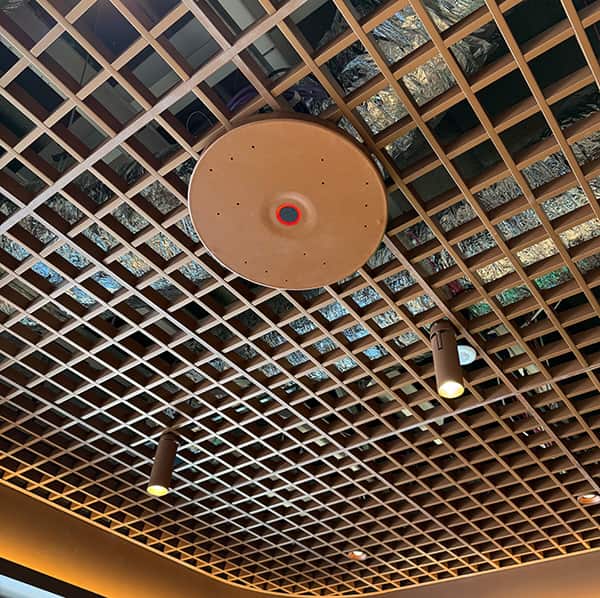 An example of the Sennheiser TCC M color matching to the waffle ceiling cover—bringing design and function together in the meeting room.