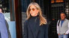 Jennifer Aniston in coat, roll neck and sunnies