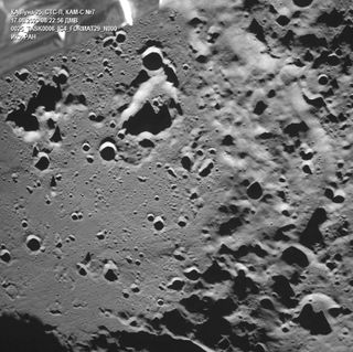 craters of all sizes and depths stretch across the surface of the moon's gray surface