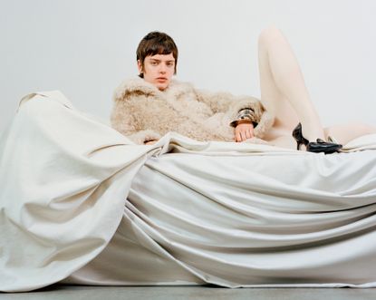Pre-Fall 2024 Best Looks Fashion Shoot featuring woman in shearling jacket on draped fabric