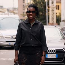 nikki ogunnaike wearing a black button-down shirt 