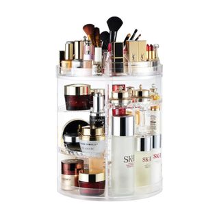 A rotating makeup organizer with cosmetics in it