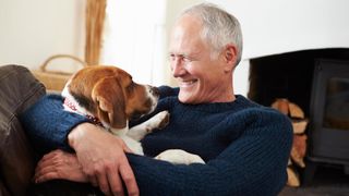 Senior man hugging his dog