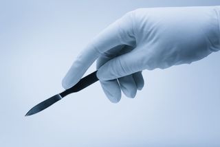 A surgeon holding a scalpel.
