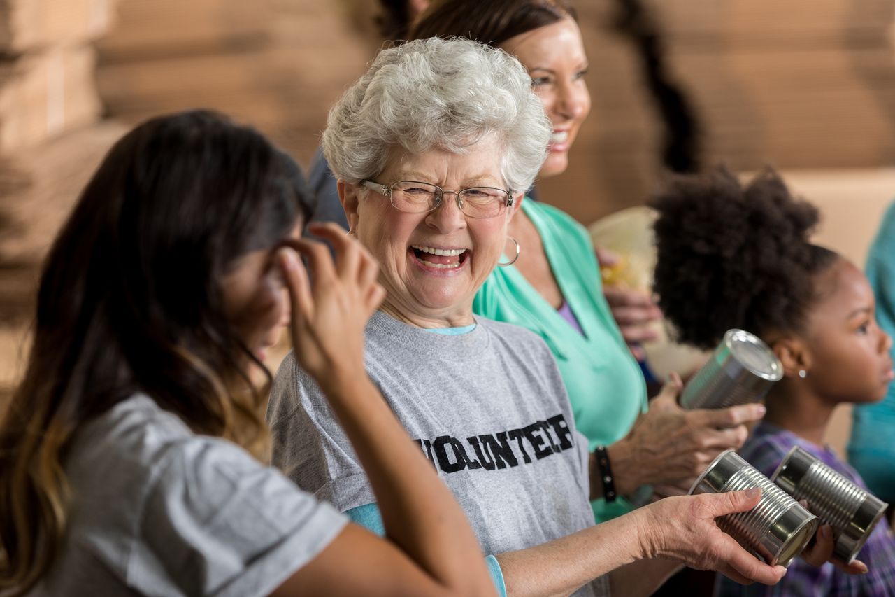 A volunteer helps sort through canned goods