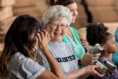 A volunteer helps sort through canned goods