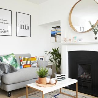 grey sofa beside fireplace and coffee table inside living room