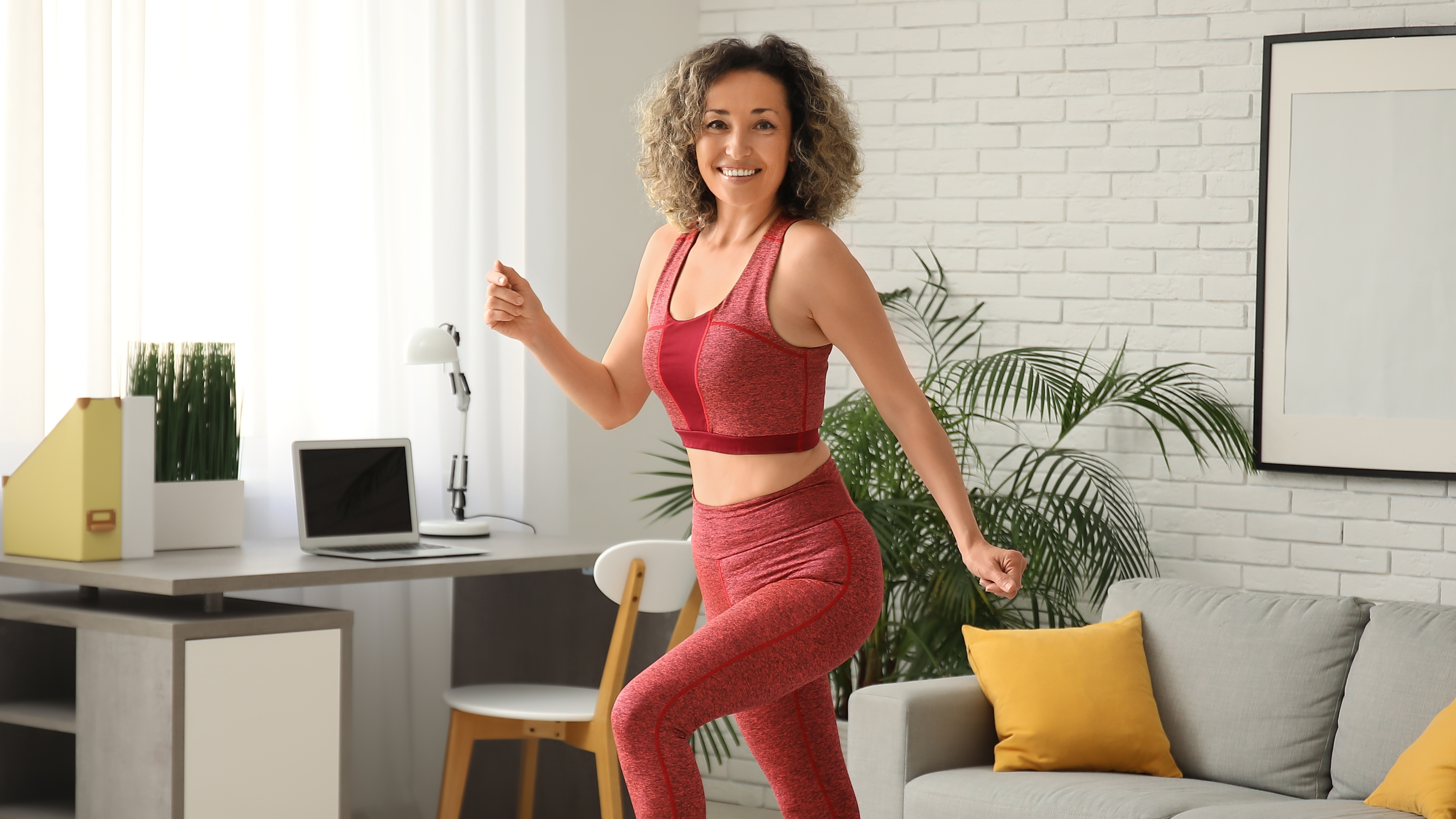 a woman doing a walking workout at home