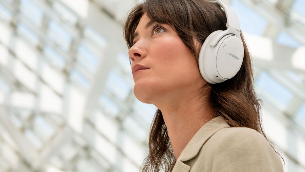 Person wearing Bose QuietComfort headphones