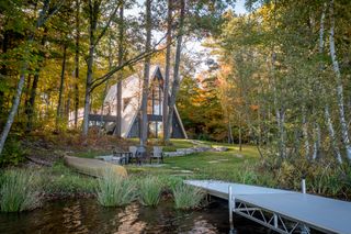 View from the water of the Lake Placid A-Frame house by Strand Design