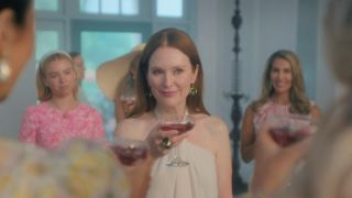 Julianne Moore toasting with Milly Alcock behind her in Netflix's Sirens.