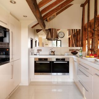 kitchen room with white tiled flooring and u shaped kitchen worktop