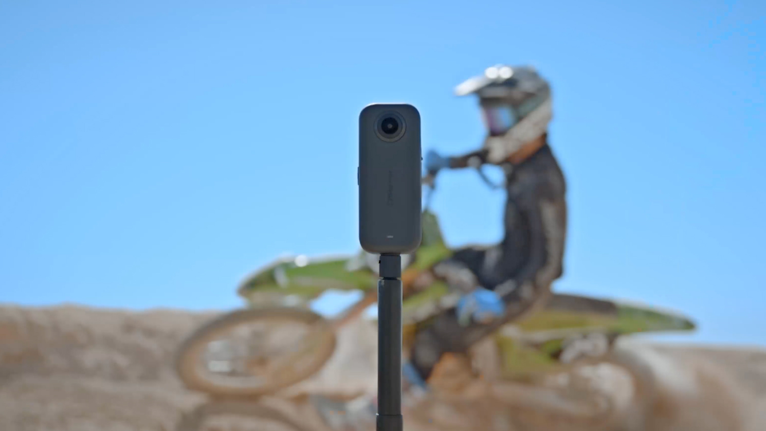 Akaso 360 action camera with dirt bike behind it