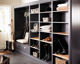 Hallway with built-in boot room storage and dark flooring