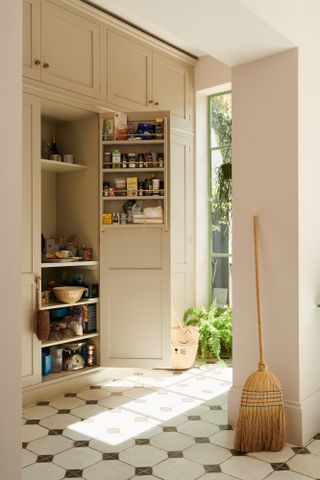 Small pantry in a light filled cream kitchen by deVOL