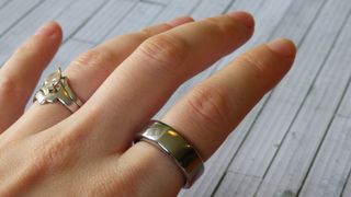 Woman's hand wearing Oura smart ring