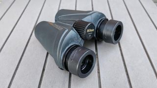 The Nikon Travelite EX 8x25 binoculars on a table with the eye cups closest to the camera
