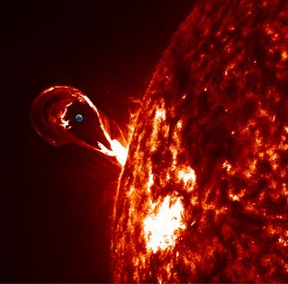 View of a typical solar eruption using data from NASA's Solar Dynamic Observatory spacecraft. Earth depicted for scale.