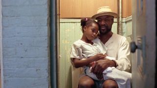 Delroy Lindo holding Zelda Harris in Crooklyn.