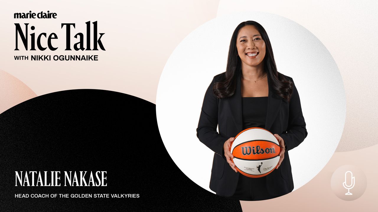 a press shot of natalie nakase holding a basketball and wearing a black suit 