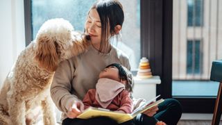 Dog sitting with mom and baby