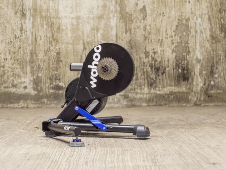 Side angle of Wahoo Kickr V6 outdoors in front of a wall 