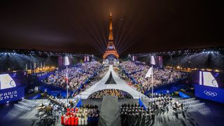 Olympic Games - the Eiffel Tower at night with rings and crowd