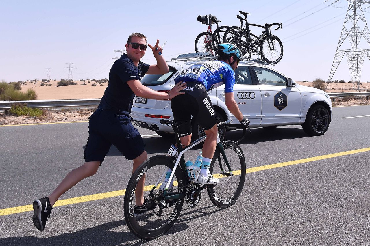 Mechanic Nicolas Coosemans shows off to the camera as he pushes Mark Cavendish back into the race
