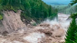 A still from a video shows raging floodwaters that surged across Yellowstone National Park in June 2022.