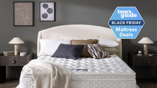 Premier Inn mattress in a brightly lit hotel room with a pillows and a blanket on the bed and a TG Black Friday mattress deals badge on the right side