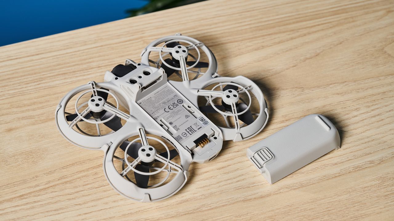 A gray DJI Neo drone with a camera