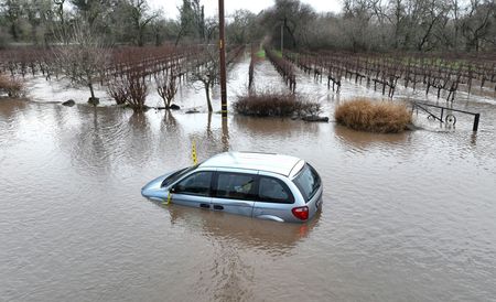 a car is submerged in floodwater.