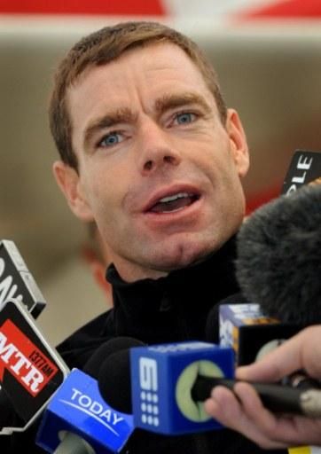 Evans talks to the media on the tarmac at Melbourne Airport