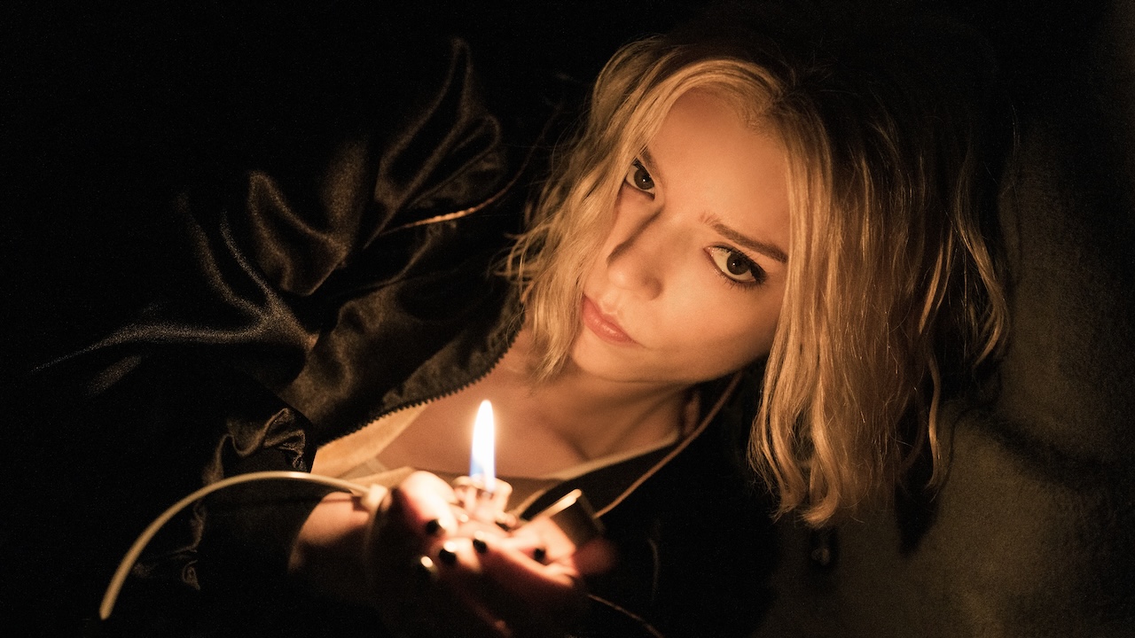 Anya Taylor Joy holding a lit up lighter in Lucky