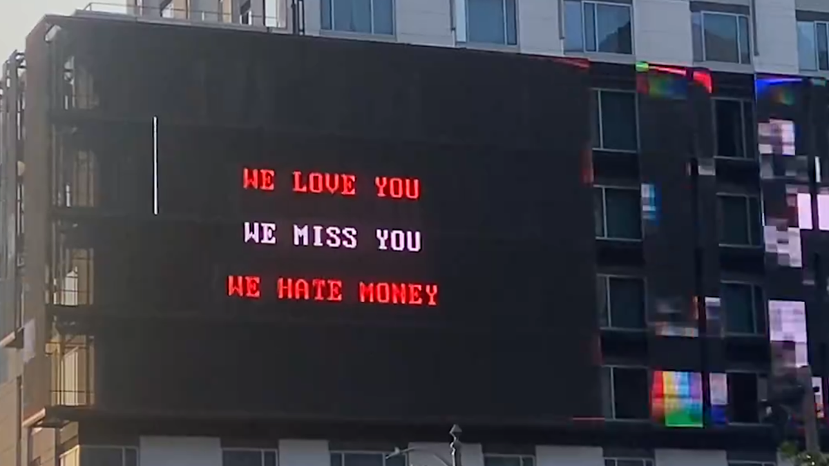 A billboard that reads: &quot;WE LOVE YOU, WE MISS YOU, WE HATE MONEY&quot; in LA, as captured by @stephentotilo on Twitter/X.