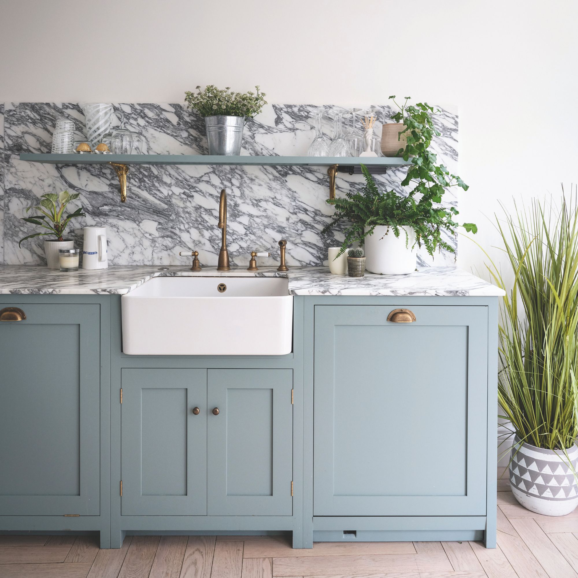 Marble kitchen worktop with dusky blue cabinets underneath