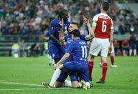 Olivier Giroud celebrates with his Chelsea team-mates after scoring against Arsenal in the Europa League final in Baku in May 2019.