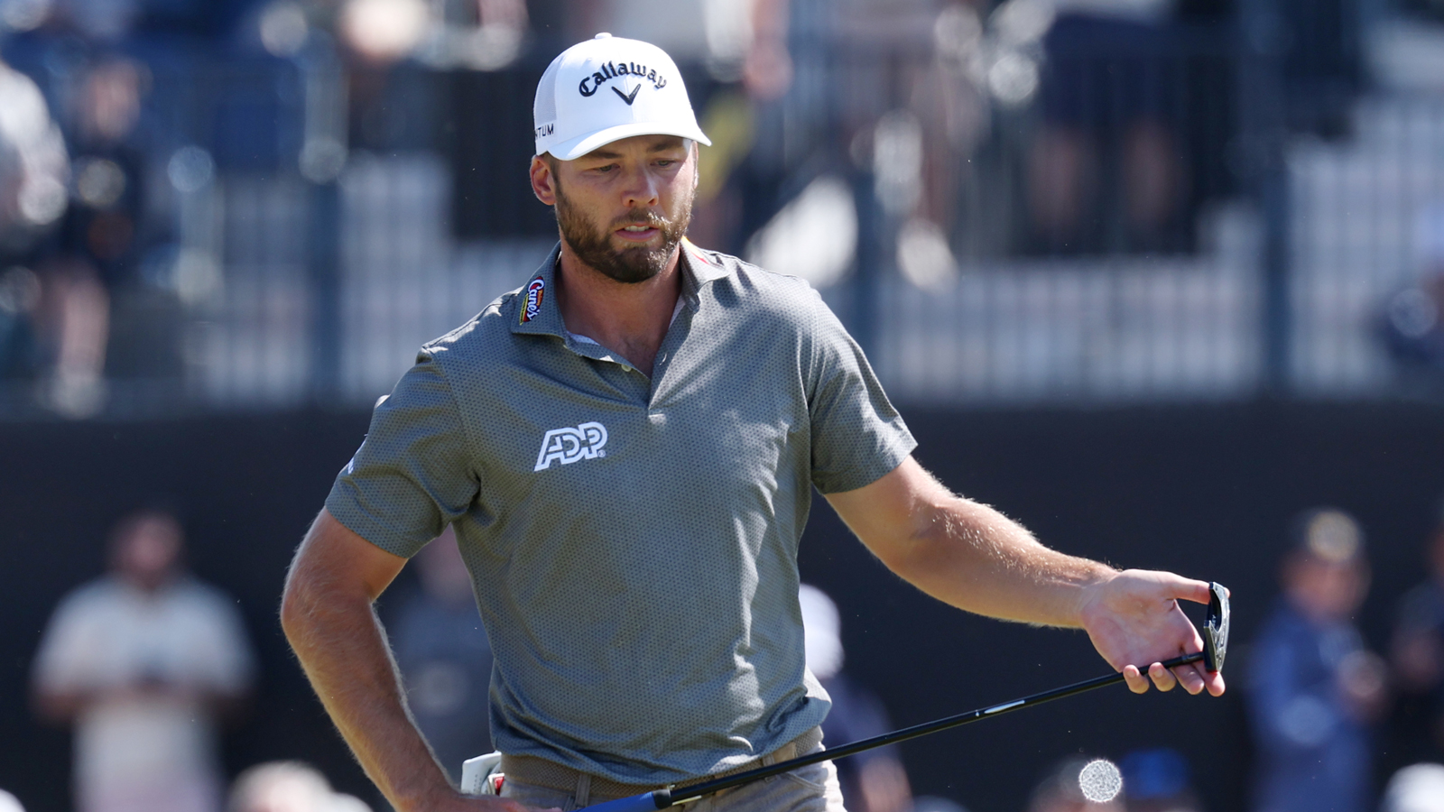 Sam Burns walks into a putt