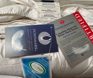 Down certifications and care tags on the Brooklinen Down Comforter.
