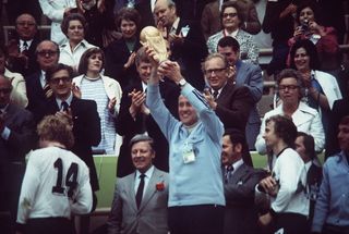 West Germany coach Helmut Schon lifts the World Cup trophy in 1974.