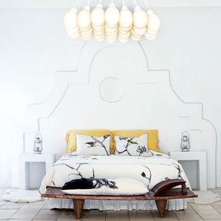 bedroom with white walls and chandelier