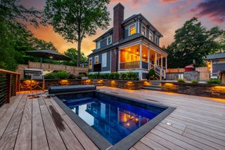 A plunge pool in a yard on an evening with ambient lighting