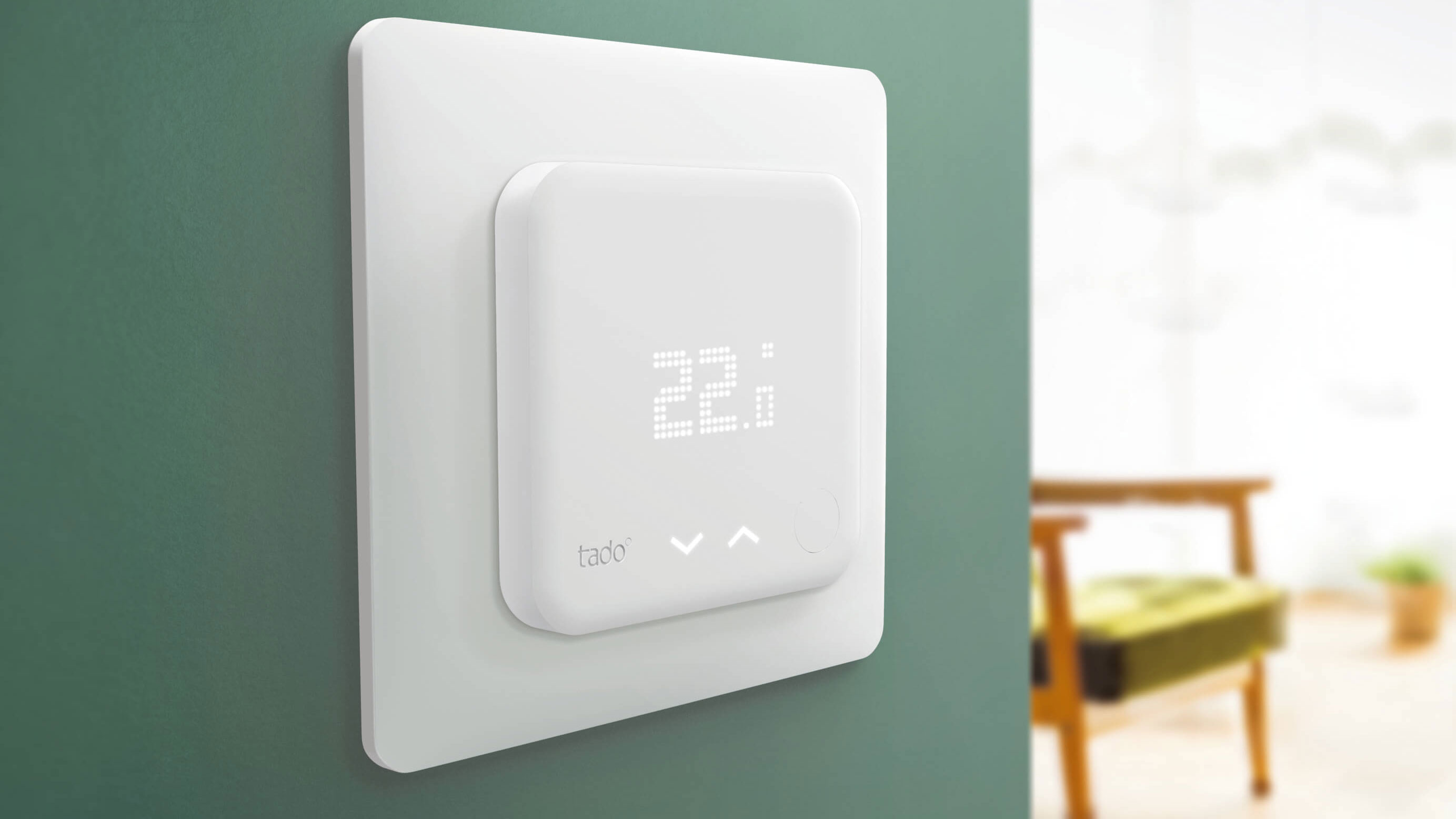 Tado Smart Thermostat montert på en vegg