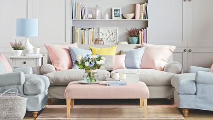 Pink ombre walls in home office with white floating shelves and plant on floor