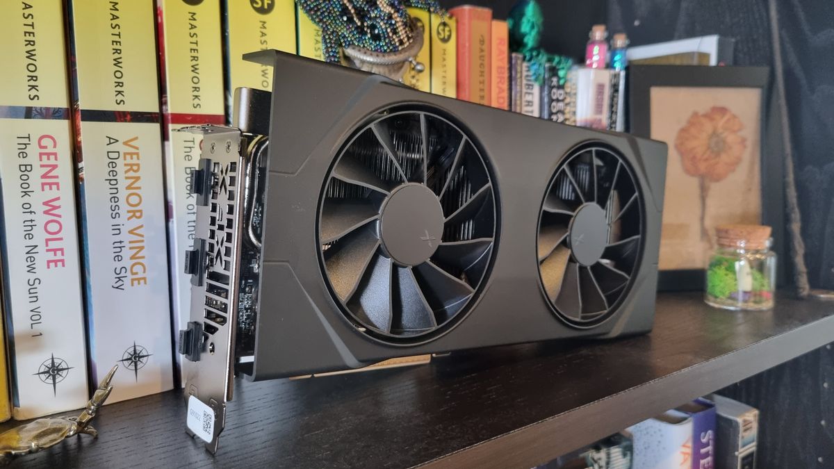 The XFX Swift AMD Radeon RX 9060 XT on a set of bookshelves, with various sci-fi novels behind it